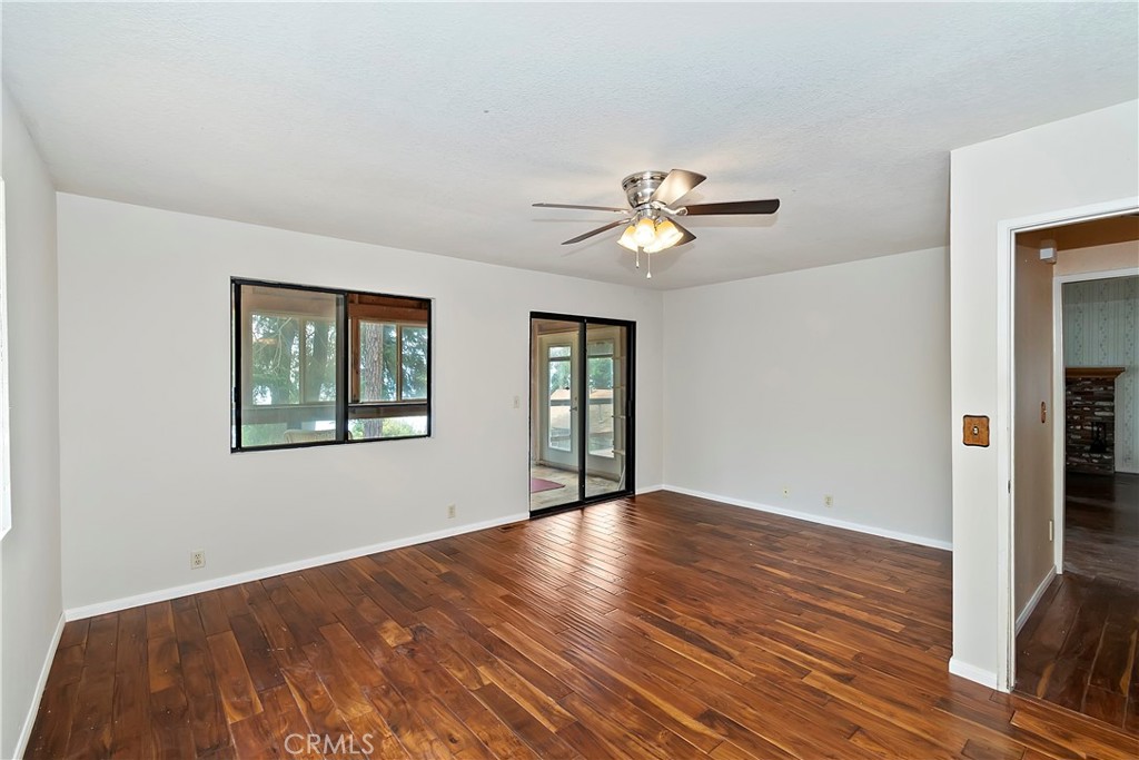 23919 Inspiration Crestline, CA 92325 - Photo 14 of 43 a view of an empty room with wooden floor and a window