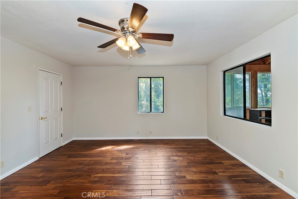 23919 Inspiration Crestline, CA 92325 - Photo 16 of 43 a view of an empty room with wooden floor and a window