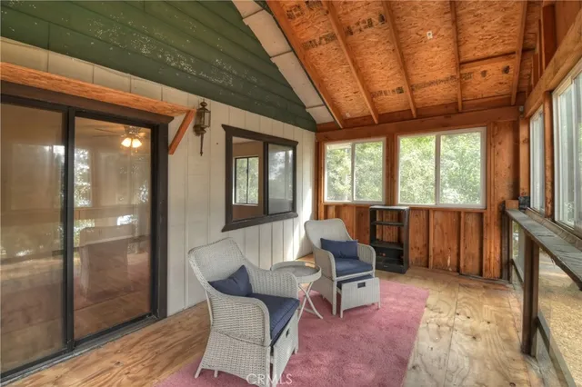 a living room with furniture a wooden floor and next to a window