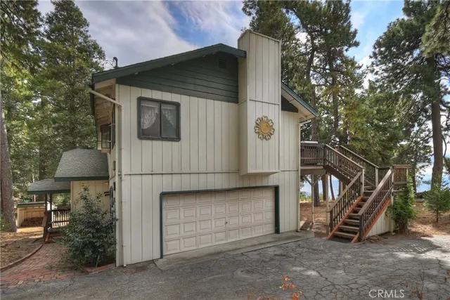 a view of a house with a door and wooden fence