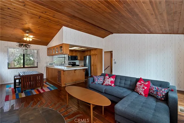 a living room with furniture and kitchen view