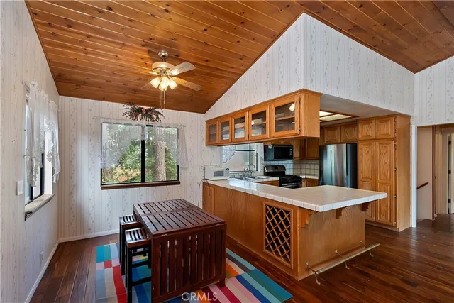 a living room with a table chairs and a wooden floor