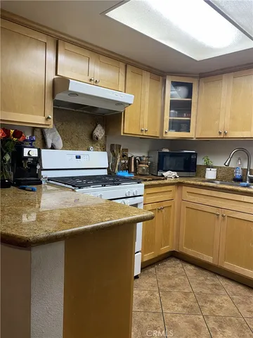 a kitchen with kitchen island a sink a counter top space and appliances