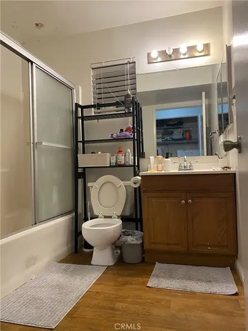 a bathroom with a toilet a sink and mirror