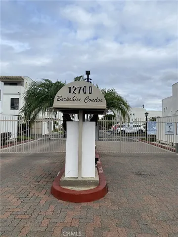 a view of a white house in front of a yard