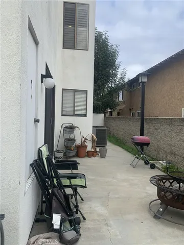 a living room with furniture a dining table and a potted plant