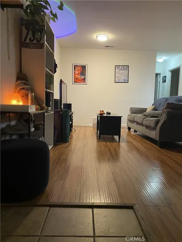 a living room with furniture and a lamp