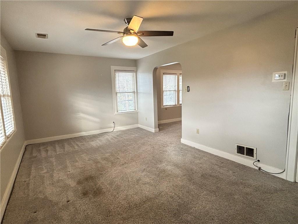 2662 Beaver Road Ambridge, PA 15003 - Photo 11 of 22 an empty room with windows and ceiling fan