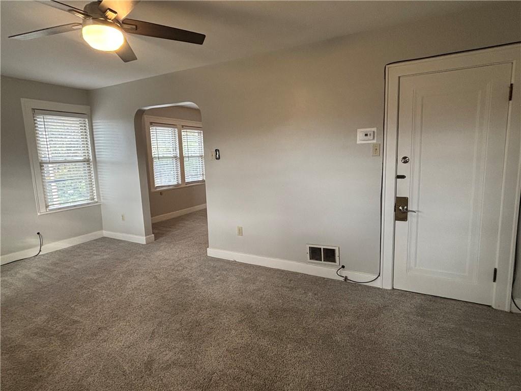 2662 Beaver Road Ambridge, PA 15003 - Photo 12 of 22 an empty room with chandelier fan and windows