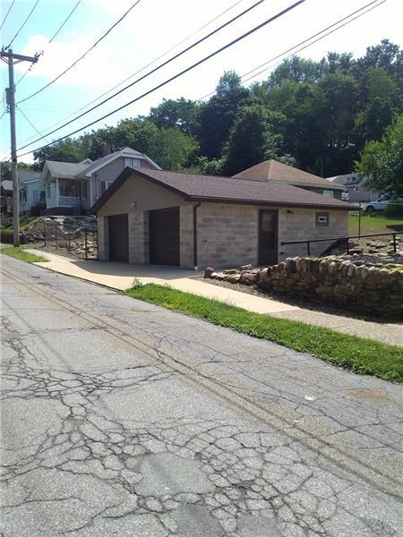 2662 Beaver Road Ambridge, PA 15003 - Photo 21 of 22 a front view of a house with a yard and a garage