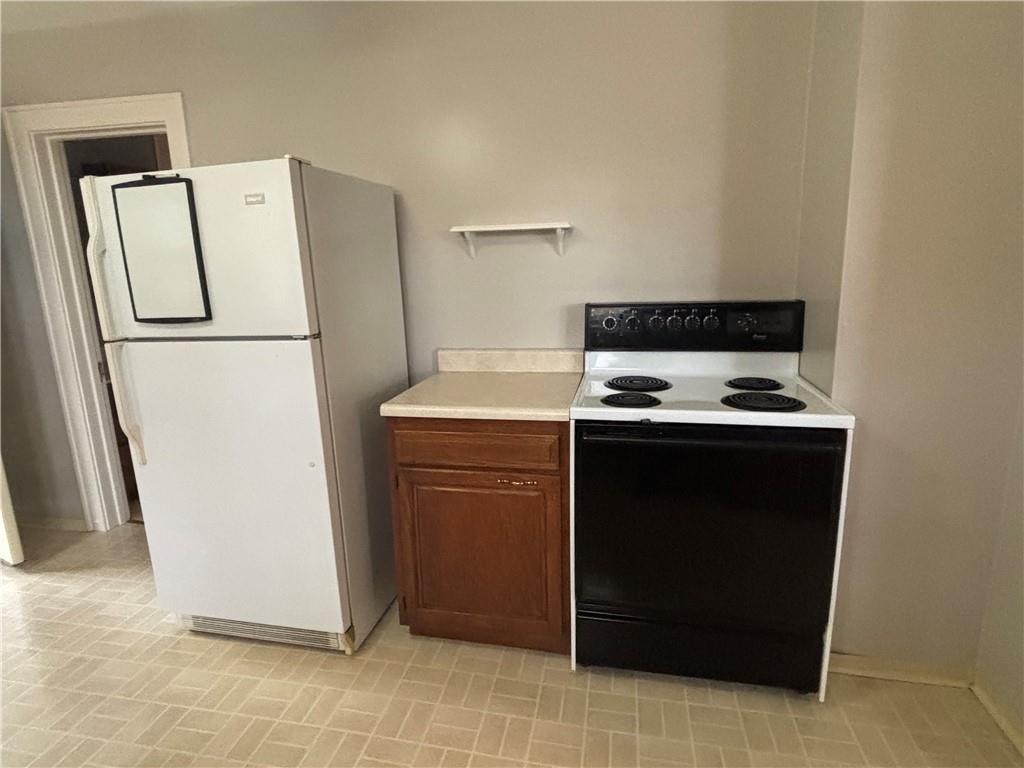 2662 Beaver Road Ambridge, PA 15003 - Photo 5 of 22 a white refrigerator freezer and a stove sitting inside of a kitchen