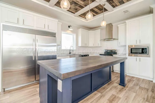 a kitchen with granite countertop white cabinets and sink