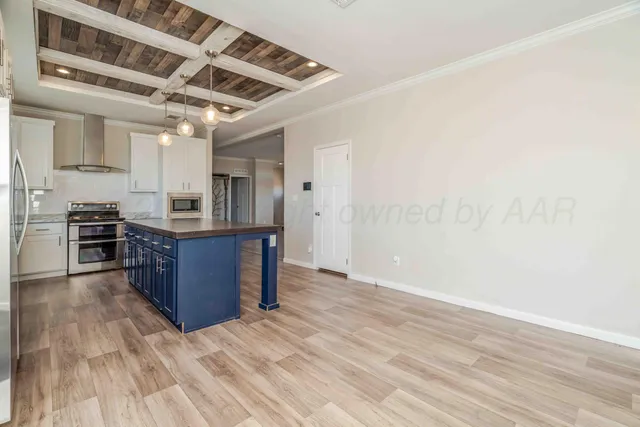 a view of a room with wooden floor and windows