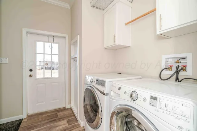 a view of a storage and utility room with washer and dryer