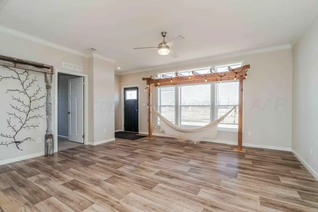 a bedroom with a large bed and a chandelier fan