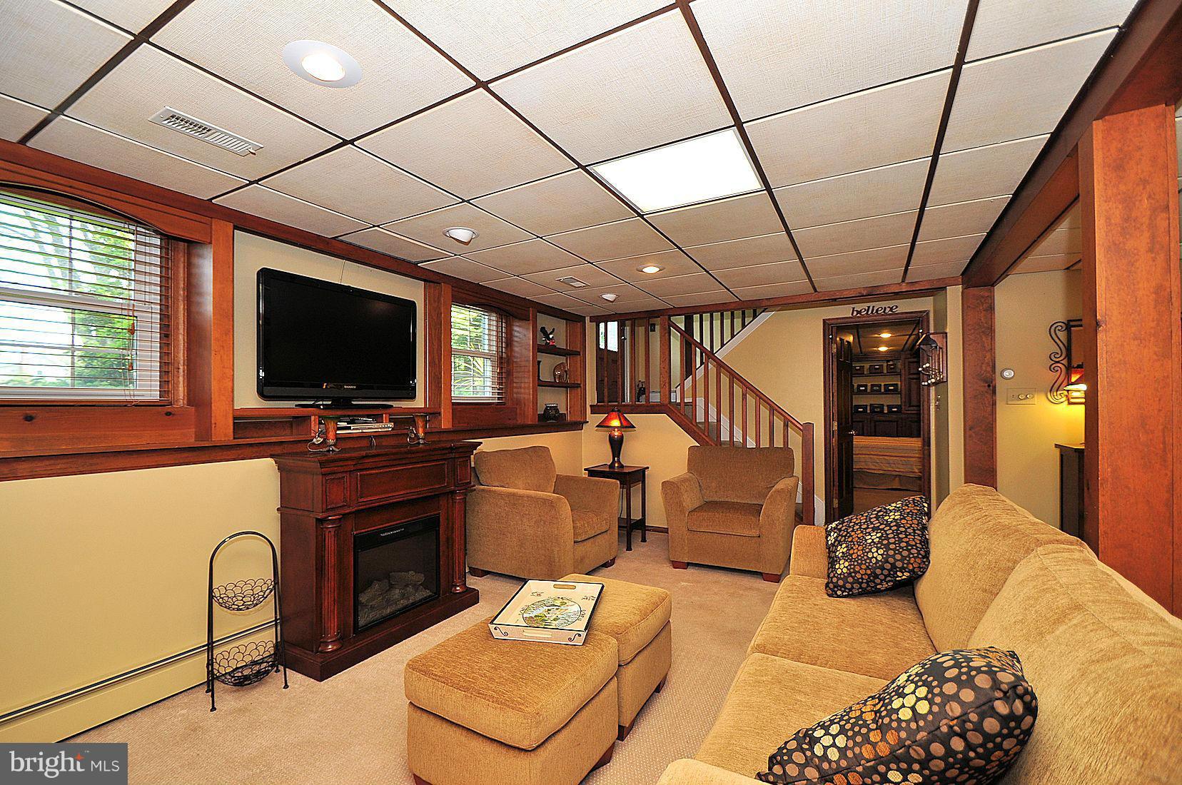 14829 Old Hanover Road Upperco, MD 21155 - Photo 22 of 30 a living room with furniture a flat screen tv and a refrigerator