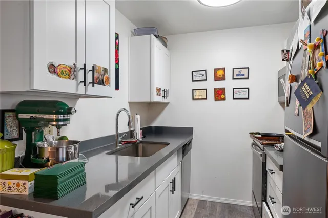 a kitchen with stainless steel appliances granite countertop a sink and cabinets