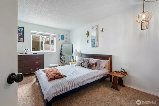 a bedroom with a bed and dresser