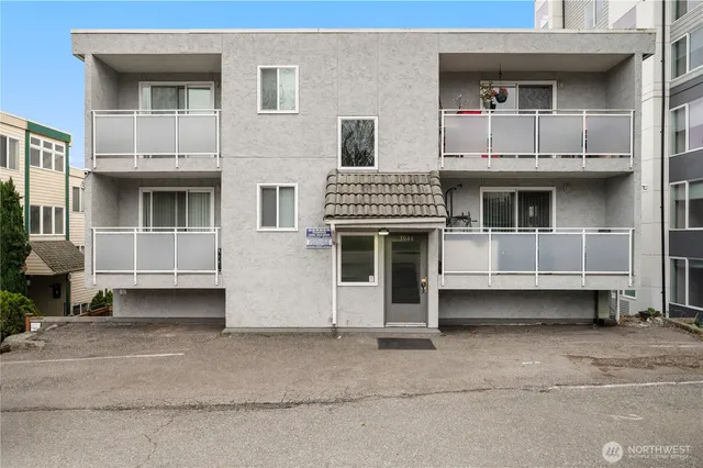 a front view of a house with a white gate
