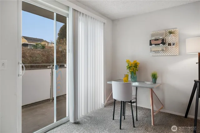 a view of a workspace with furniture and a window