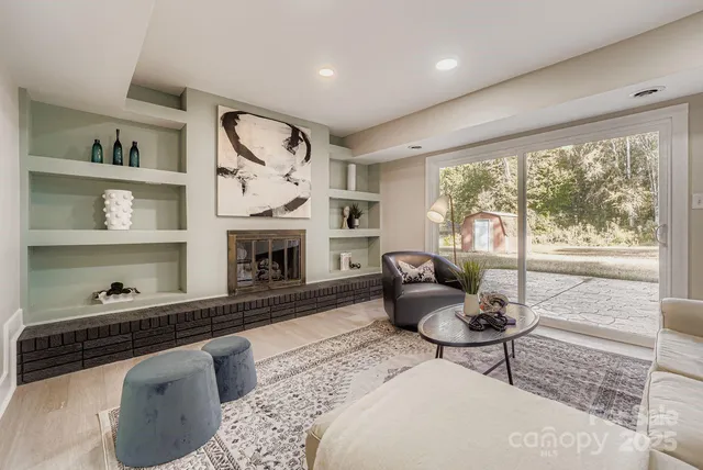 a living room with furniture fireplace and window