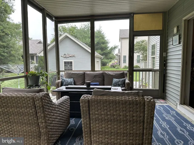 a living room with furniture a chandelier and a flat screen tv