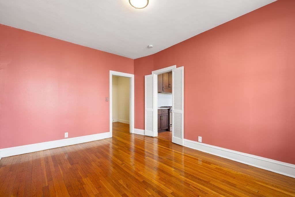 321 Tappan Street, Unit 2 Brookline, MA 02445 - Photo 11 of 25 a view of an empty room with wooden floor