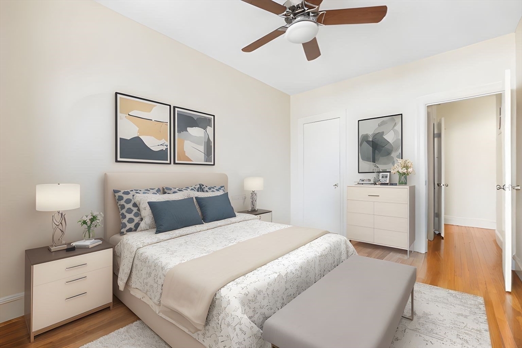 321 Tappan Street, Unit 2 Brookline, MA 02445 - Photo 16 of 25 a bedroom with a bed and a chandelier