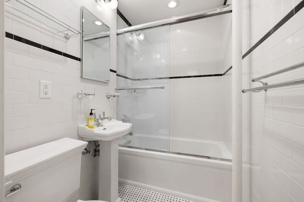 321 Tappan Street, Unit 2 Brookline, MA 02445 - Photo 19 of 25 a bathroom with a sink mirror bathtub and shower