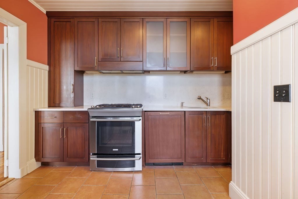 321 Tappan Street, Unit 2 Brookline, MA 02445 - Photo 6 of 25 a view of cabinets and wooden floor