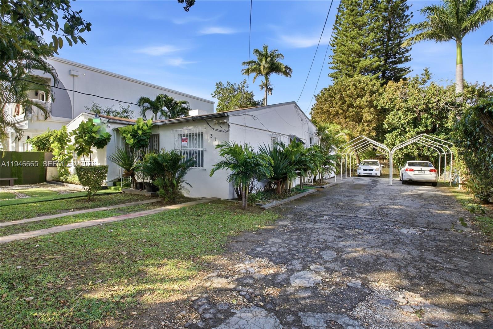 3318 Northwest 19th Avenue, Unit 1 Miami, FL 33142 - Photo 12 of 12 a front view of a house with garden