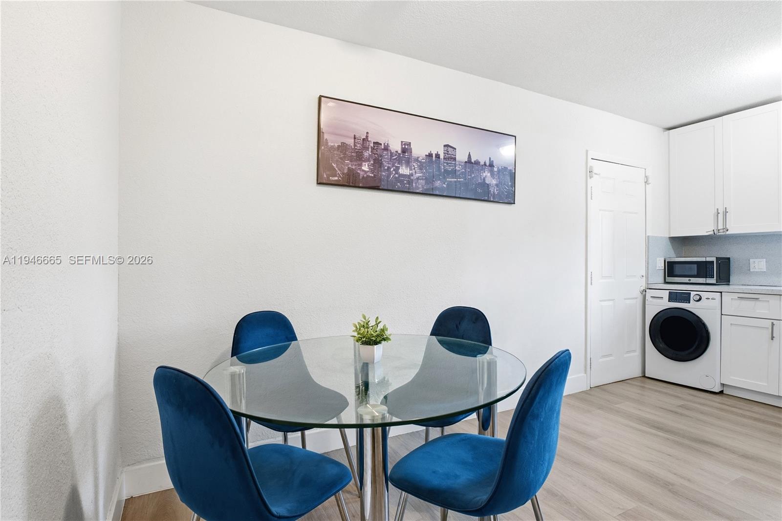 3318 Northwest 19th Avenue, Unit 1 Miami, FL 33142 - Photo 3 of 12 a view of a dining room with furniture and wooden floor