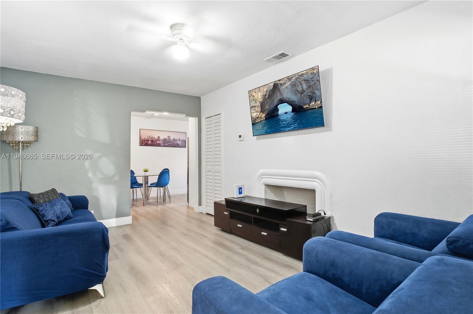 3318 Northwest 19th Avenue, Unit 1 Miami, FL 33142 - Photo 5 of 12 a living room with furniture and a fireplace