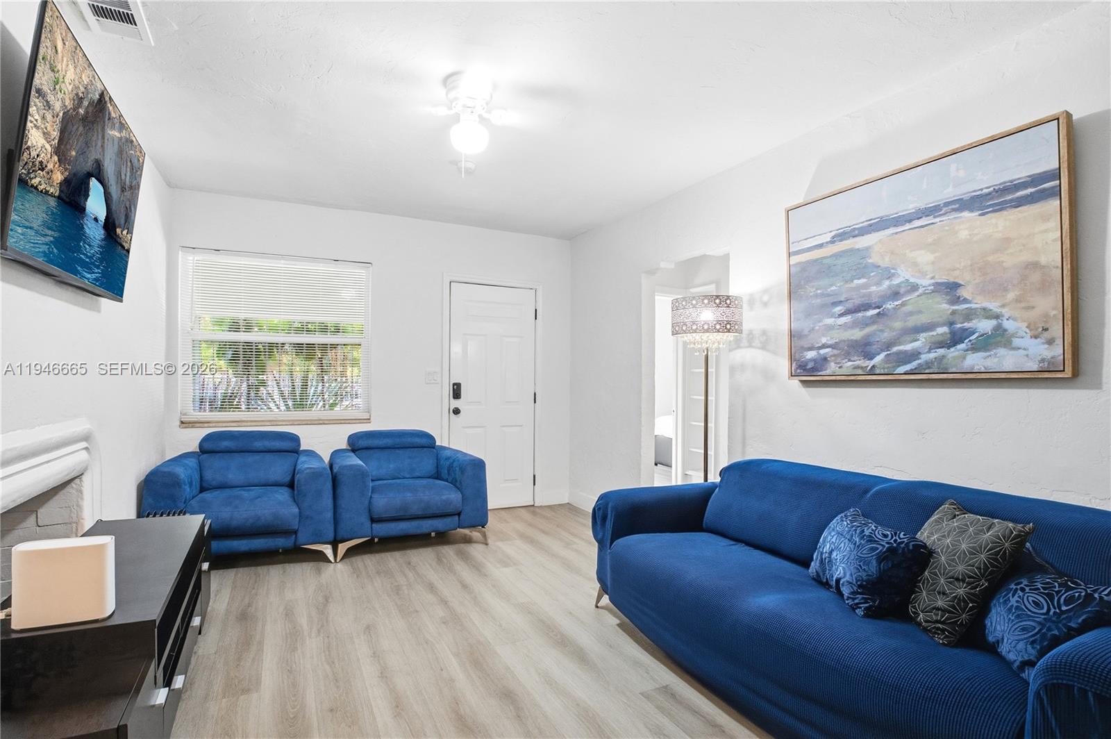 3318 Northwest 19th Avenue, Unit 1 Miami, FL 33142 - Photo 6 of 12 a living room with furniture and a window