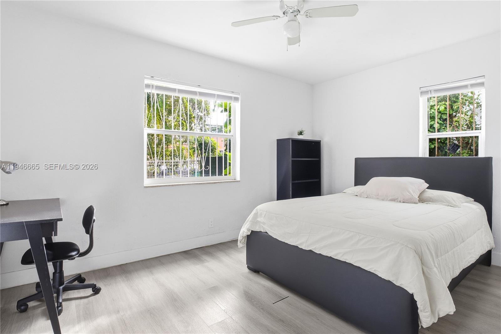 3318 Northwest 19th Avenue, Unit 1 Miami, FL 33142 - Photo 8 of 12 a bedroom with a bed and a window