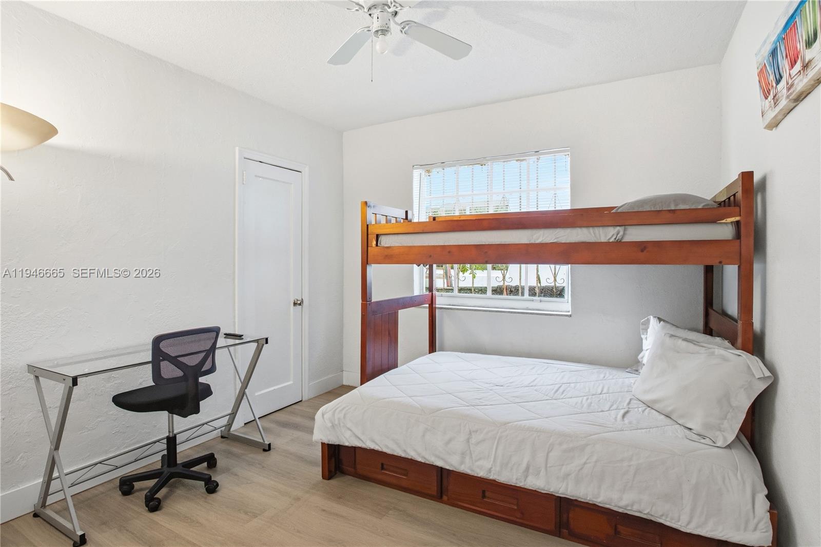 3318 Northwest 19th Avenue, Unit 1 Miami, FL 33142 - Photo 10 of 12 a bedroom with a bed and a chair