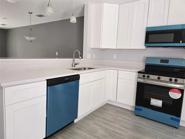 a kitchen with a stove and a microwave