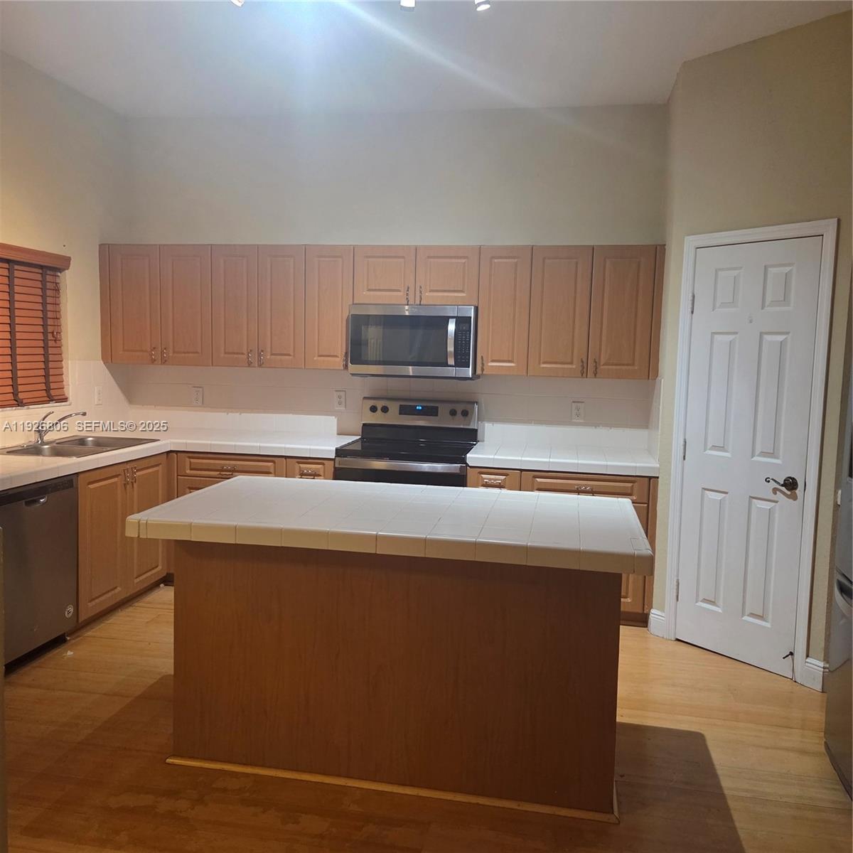1938 Southeast 23rd Terrace, Unit 1938 Homestead, FL 33035 - Photo 2 of 7 a kitchen with a cabinets and a stove top oven