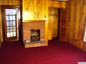2471 Starnes Road Edgemoor, SC 29712 - Photo 3 of 10 a view of an empty room with a fireplace and a window