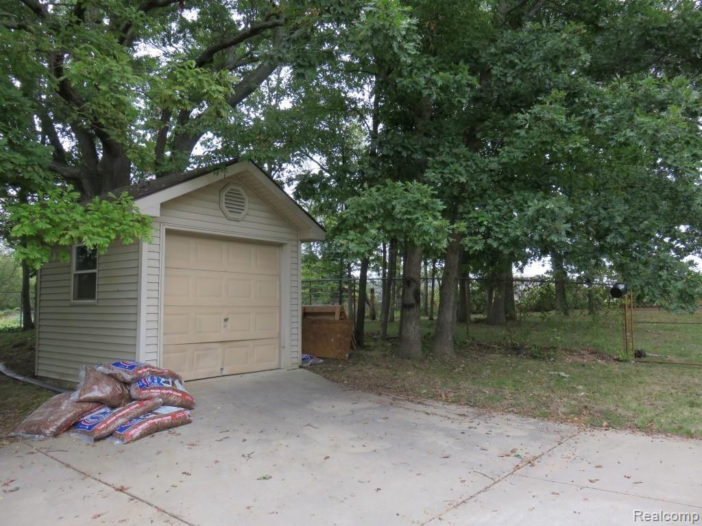 2611 Pinckney Road Howell, MI 48843 - Photo 48 of 55 10 x 10 vinyl sided shed with concrete floor, plus additional storage available through cabinets in attached garage