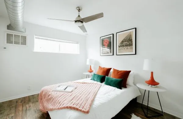 a bedroom with a bed and a lamp on table