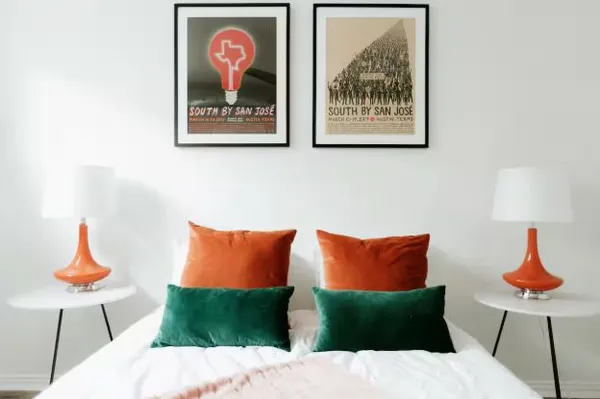 a bedroom with a bed and a painting on the wall