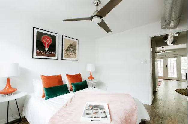 1510 West 6th Street, Unit 110 Austin, TX 78703 - Photo 16 of 18 a bedroom with a bed and a painting on the wall