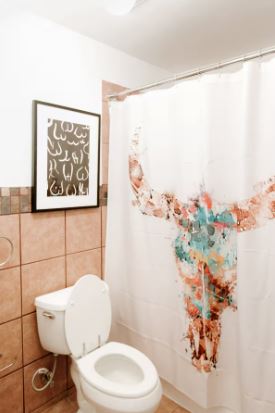 1510 West 6th Street, Unit 110 Austin, TX 78703 - Photo 17 of 18 a white toilet sitting next to a bathroom sink