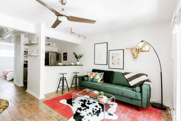 a living room with furniture and wooden floor