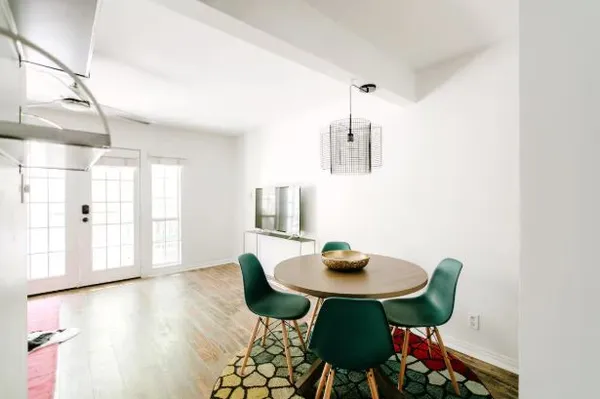 a view of a dining room with furniture and wooden floor