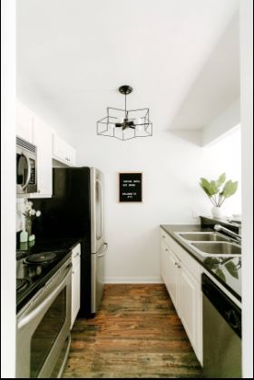 1510 West 6th Street, Unit 110 Austin, TX 78703 - Photo 8 of 18 a kitchen with stainless steel appliances granite countertop a sink stove and refrigerator