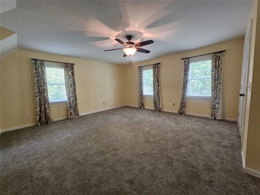 290 Oakmere Road Alpharetta, GA 30009 - Photo 19 of 26 an empty room with windows and fan