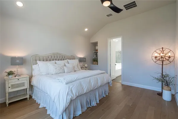 a bedroom with bed and a chandelier