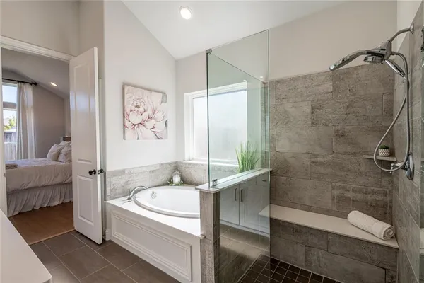 a bathroom with a tub and a shower